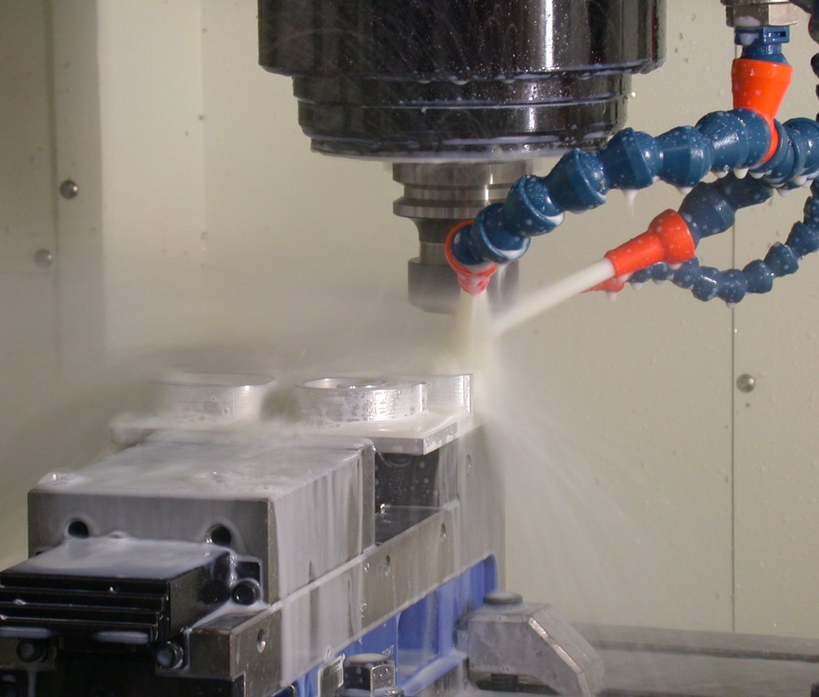 Metal part being machined on a CNC mill